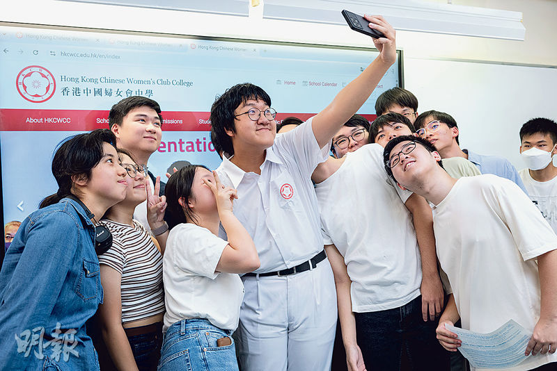 今屆唯一「終極狀元」是香港中國婦女會中學的王海博（持手機者），昨和媽媽到校，與同班同學自拍留念。他稱沒想過做狀元，自言有「luck factor（幸運成分）」。（鍾林枝攝）