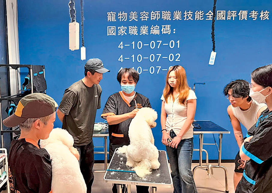 馬貫東(後排左一)開展了珠海寵物美容學校。圖為他在課堂了解學員的學習進度。
